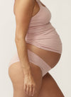 Side view of pregnant model wearing a floral nursing cami and matching bikini briefs