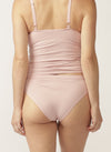 Back view of model wearing a soft pink nursing cami and matching bikini briefs