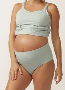  Close up of pregnant model wearing a sage green nursing cami and matching full brief wtih wide waist band