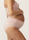 Side view of pregnant model wearing soft pink nursing cami and matching full brief with wide waist band