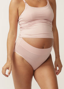  Close up of pregnant model wearing soft pink nursing cami and matching full brief with wide waist band