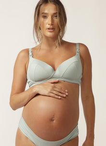  Close up of pregnant model wearing sage green nursing bra with matching briefs
