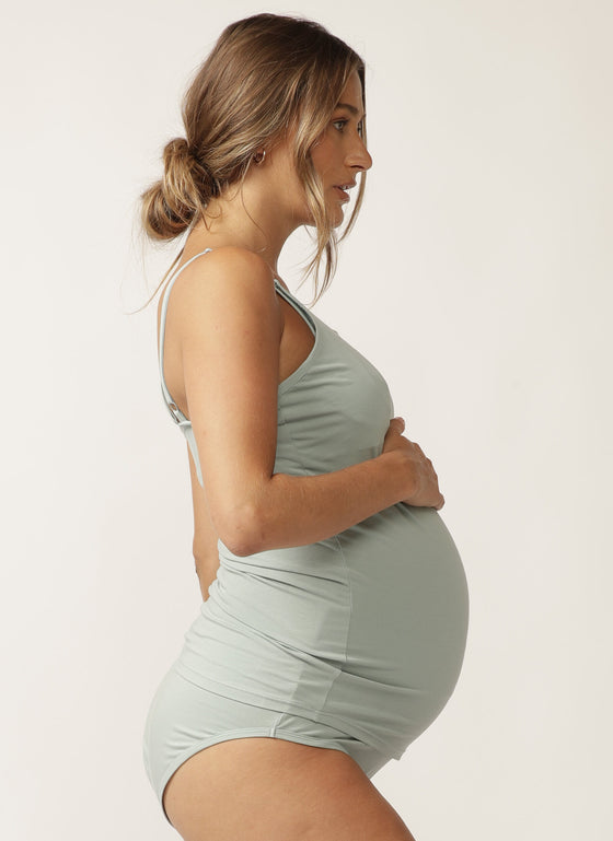  Side view of pregnant model wearing sage green nursing camisole with matching briefs