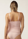 Back view of pregnant model wearing pink nursing camisole with matching briefs