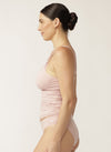 Side view of model wearing pink nursing camisole with matching briefs